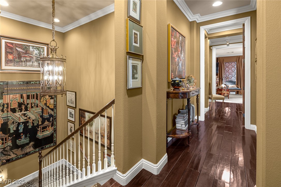 11280 Granite Ridge Drive, Unit 1057 Las Vegas, NV 89135 - Photo 20 of 46 Hallway featuring crown molding, dark wood finished floors, a chandelier, recessed lighting, and an upstairs landing