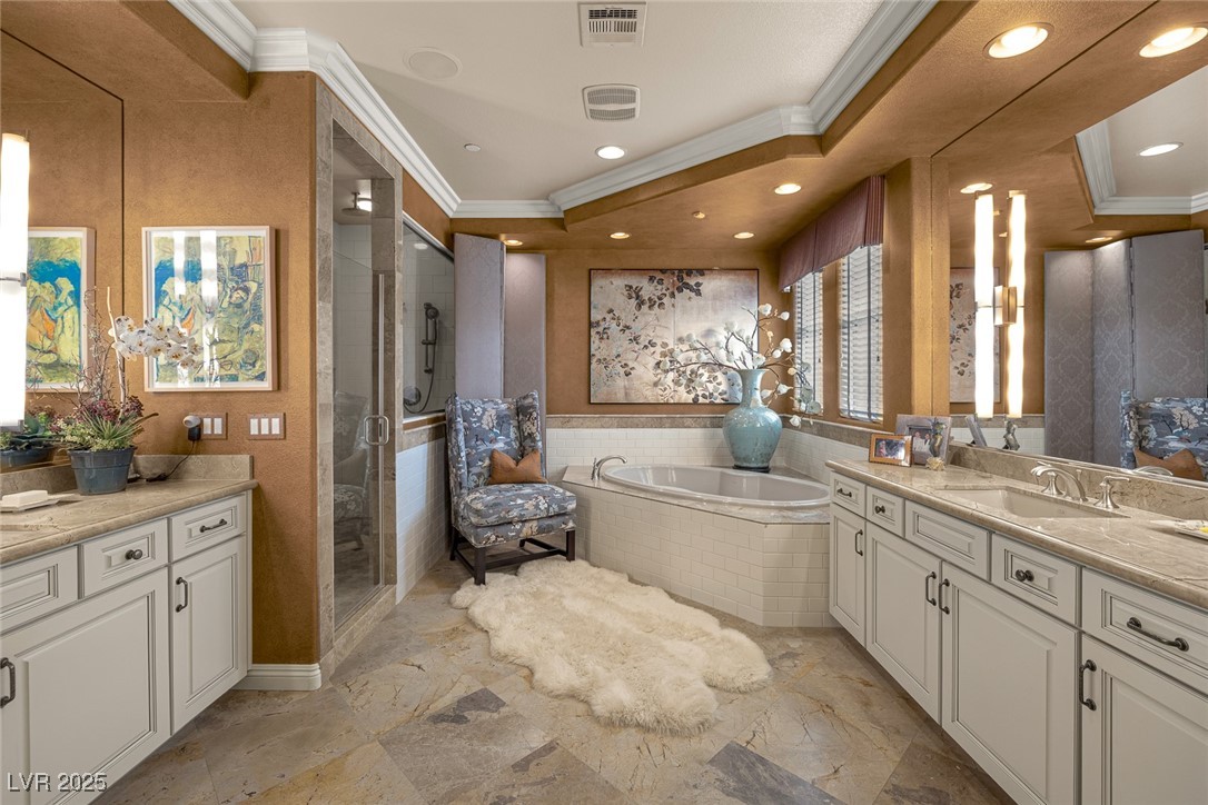 11280 Granite Ridge Drive, Unit 1057 Las Vegas, NV 89135 - Photo 25 of 46 Bathroom featuring ornamental molding, two vanities, a garden tub, a stall shower, and recessed lighting
