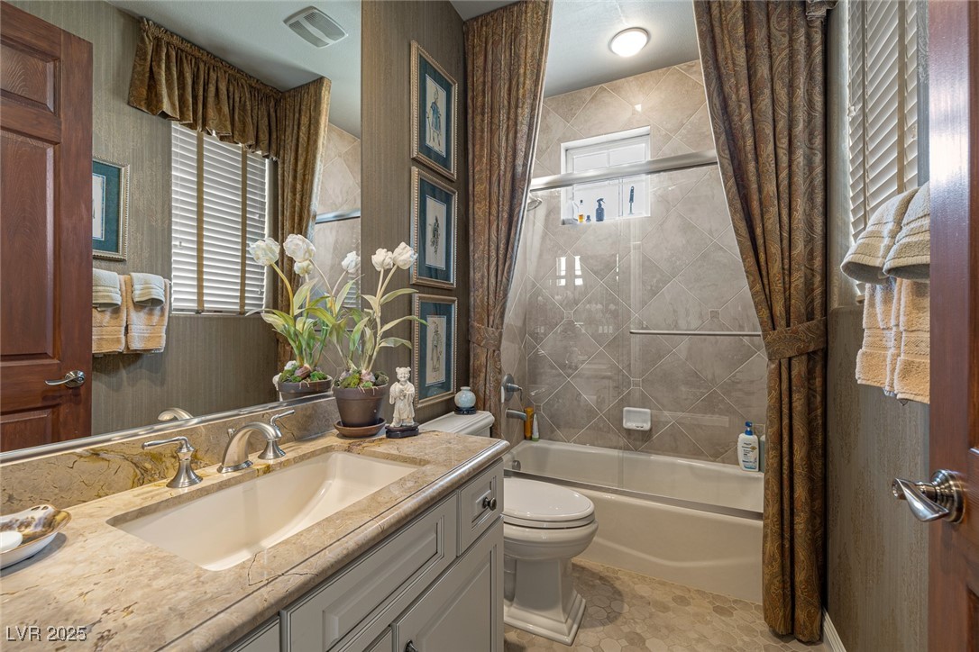 11280 Granite Ridge Drive, Unit 1057 Las Vegas, NV 89135 - Photo 28 of 46 Bathroom with wallpapered walls, enclosed tub / shower combo, vanity, and light tile patterned floors