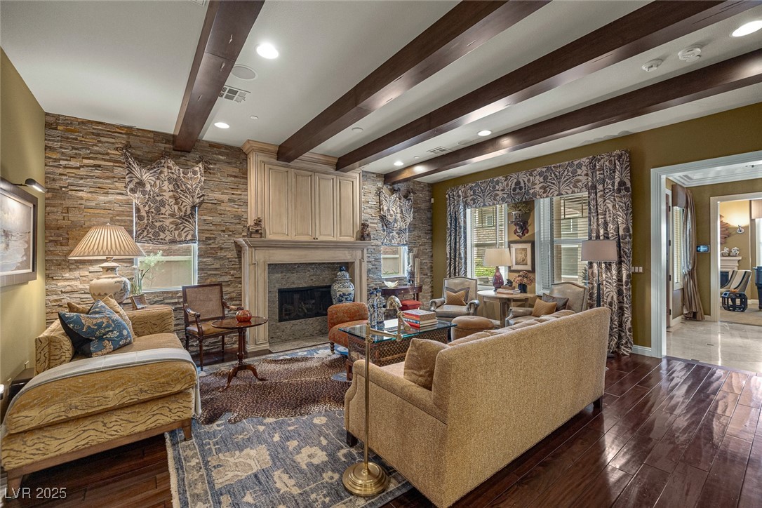 11280 Granite Ridge Drive, Unit 1057 Las Vegas, NV 89135 - Photo 7 of 46 Living area with beam ceiling, dark wood finished floors, a fireplace, and recessed lighting