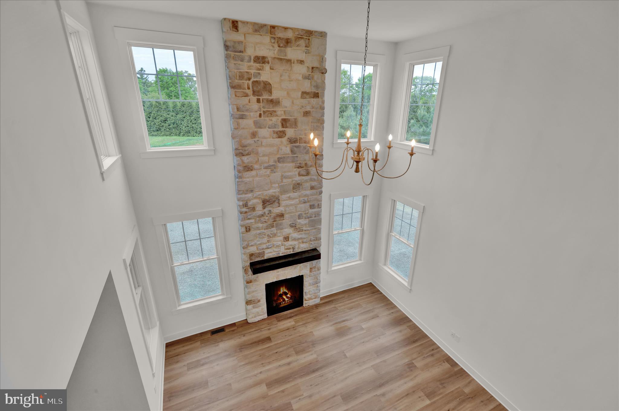 513 Cheltenham Court Lititz, PA 17543 - Photo 29 of 64 an empty room with windows wooden floor and front door