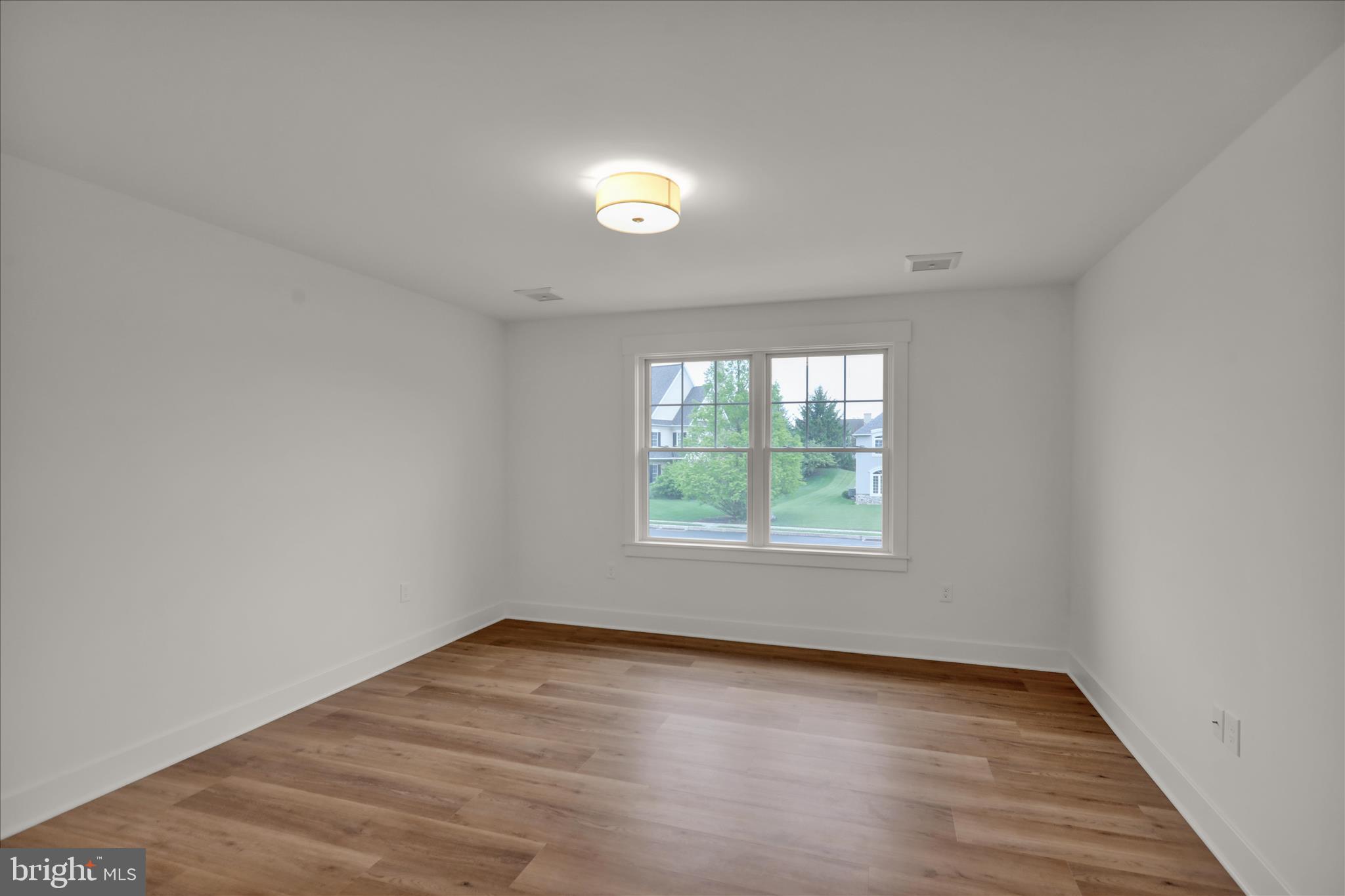 513 Cheltenham Court Lititz, PA 17543 - Photo 45 of 64 an empty room with wooden floor and windows