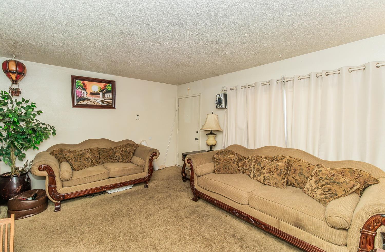 922 Music Avenue Clovis, CA 93612 - Photo 3 of 20 a living room with furniture and a couch