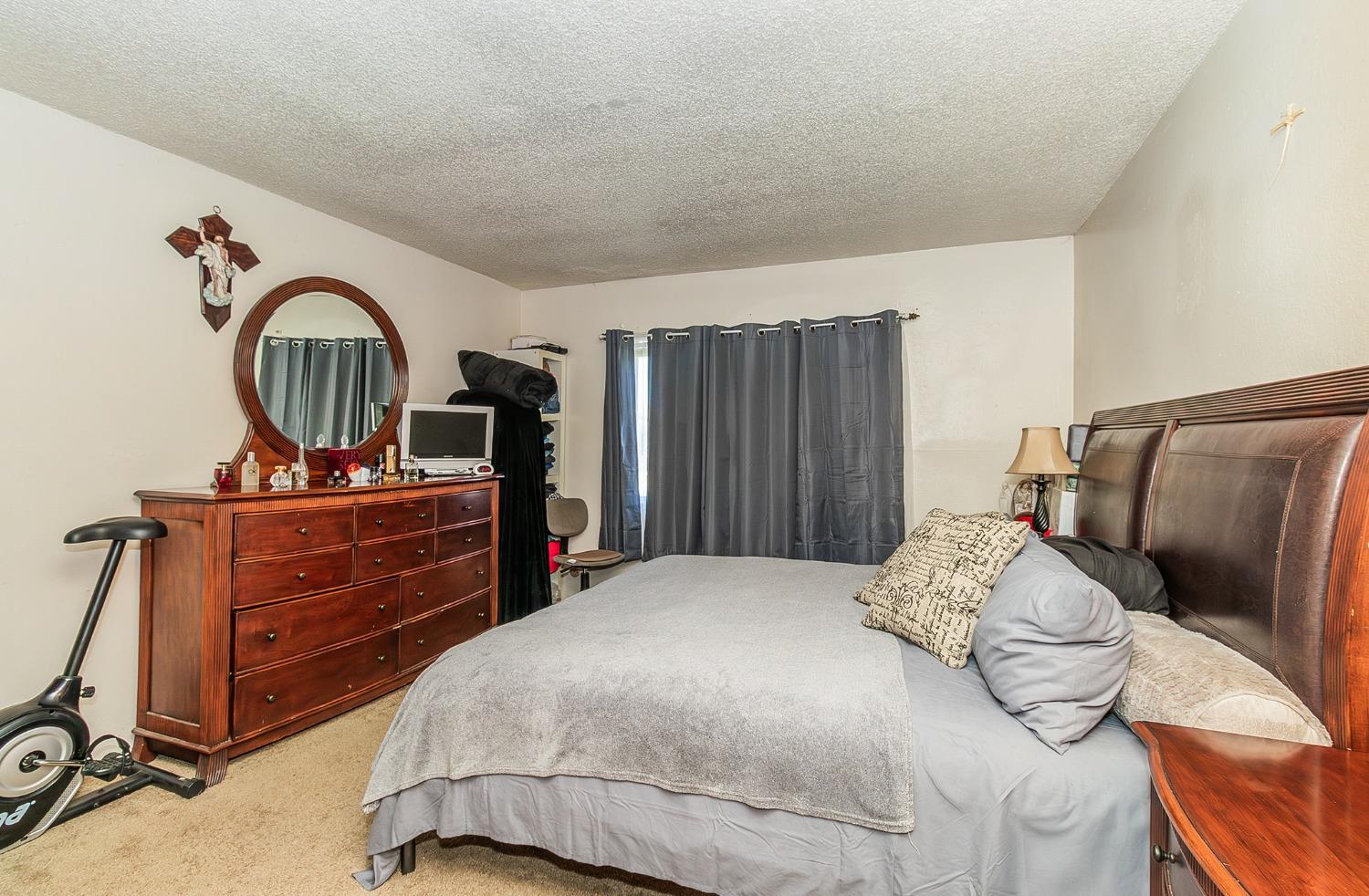 922 Music Avenue Clovis, CA 93612 - Photo 9 of 20 a bedroom with a bed and a dresser