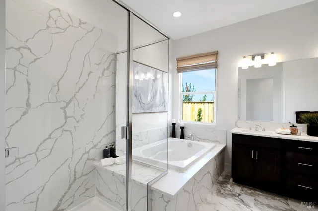 a bathroom with a granite countertop sink a toilet and shower