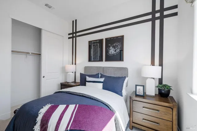 a bedroom with a bed and a potted plant