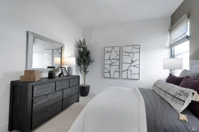 a bedroom with a large bed and a dresser