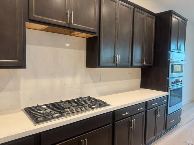 a kitchen with stainless steel appliances a stove and a refrigerator