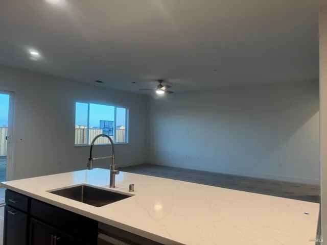 a kitchen with a sink and chandelier