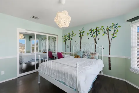 a bed room with a bed and a chandelier