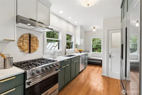 a stove top oven sitting inside of a kitchen