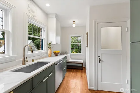 a kitchen with a refrigerator a sink and wooden cabinets