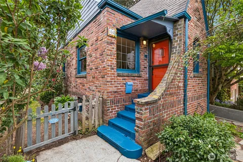 a view of a house with wooden fence and two windows