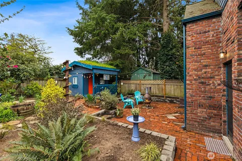 a view of a chair and table in backyard of the house