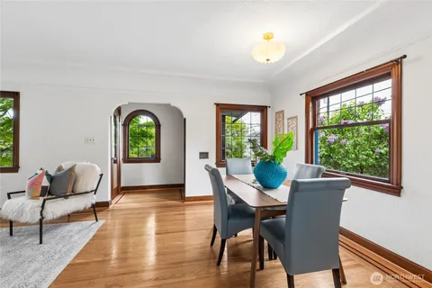 a view of a dining room with furniture window and wooden floor