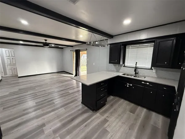 a spacious bathroom with a granite countertop sink toilet and a mirror