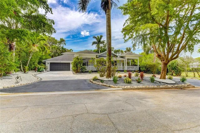 a view of a house with backyard porch and sitting area