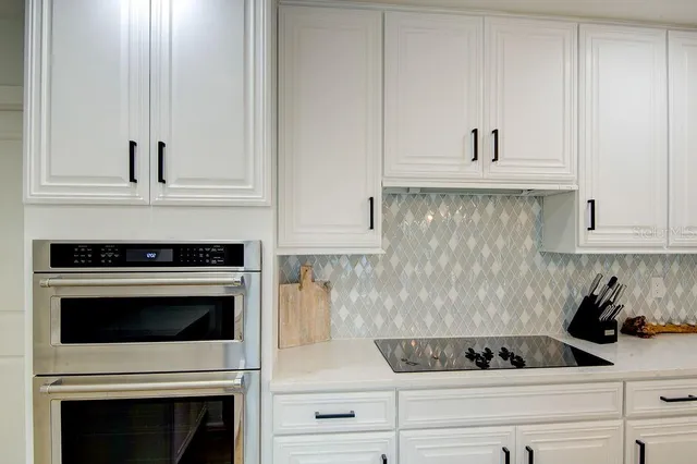a kitchen with stainless steel appliances a refrigerator sink and cabinets