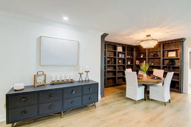 a view of a dining room with furniture and a book shelf