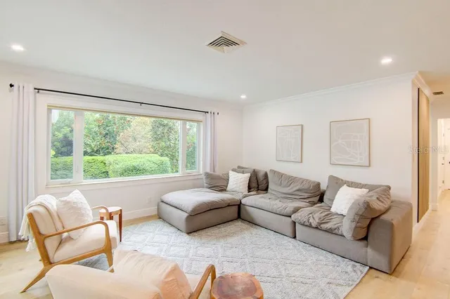 a living room with furniture kitchen view and a table