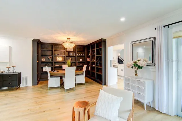 a dining room with furniture and wooden floor