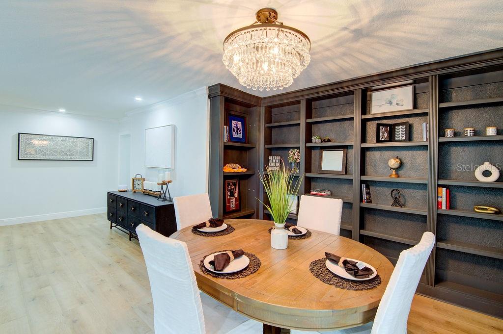 1720 Spring Creek Drive Sarasota, FL 34239 - Photo 18 of 63 a dining room with furniture and wooden floor