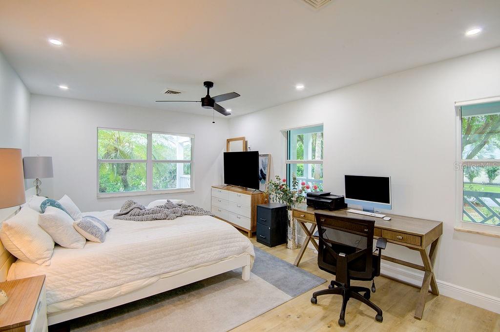 1720 Spring Creek Drive Sarasota, FL 34239 - Photo 26 of 63 a bedroom with a bed and a flat screen tv