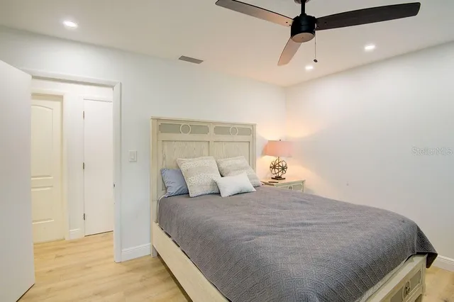 a bedroom with a bed a desk and chair