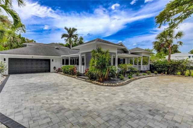 a view of a house with a yard and sitting area