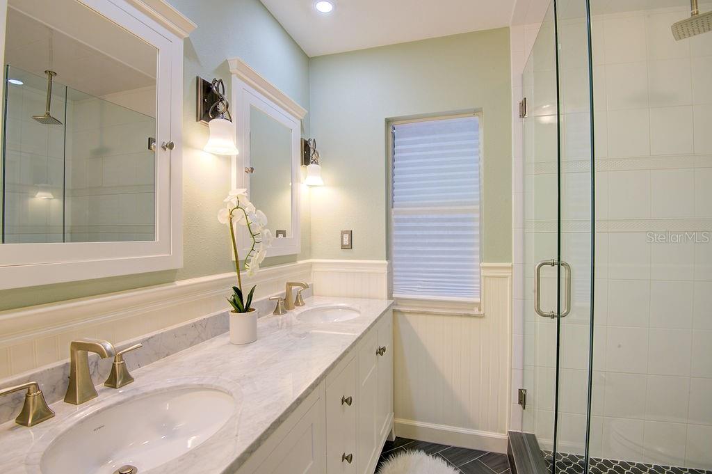 1720 Spring Creek Drive Sarasota, FL 34239 - Photo 31 of 63 a bathroom with a granite countertop sink and a mirror