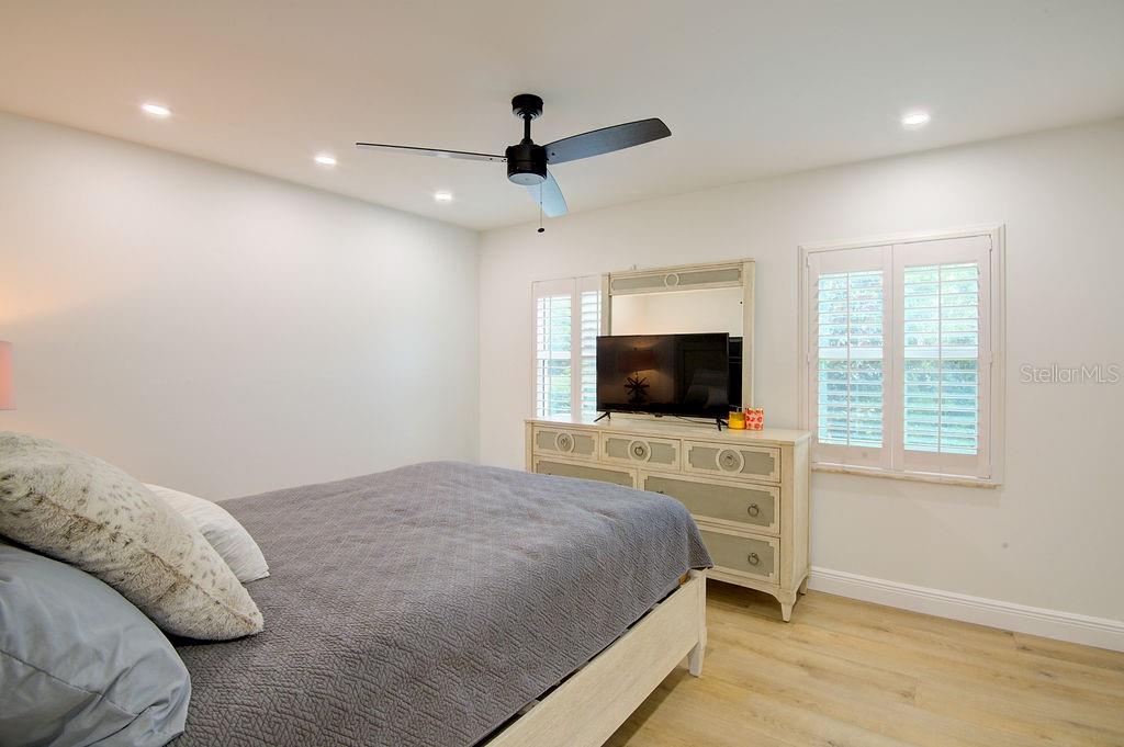 1720 Spring Creek Drive Sarasota, FL 34239 - Photo 33 of 63 a bedroom with a bed and a flat screen tv