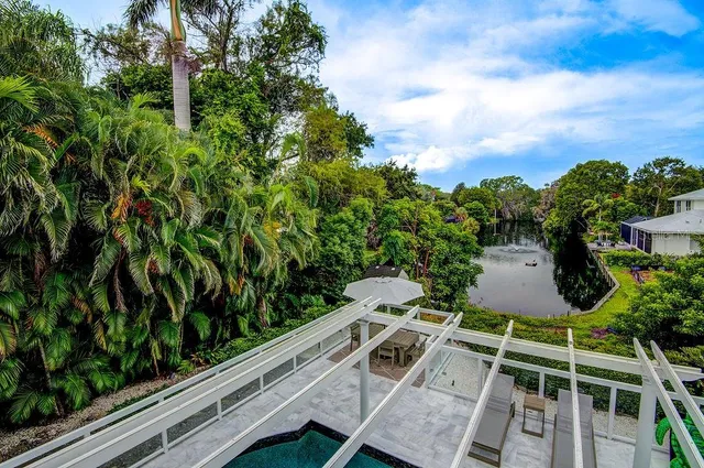 a view of a patio with couches chairs and a table and potted plants