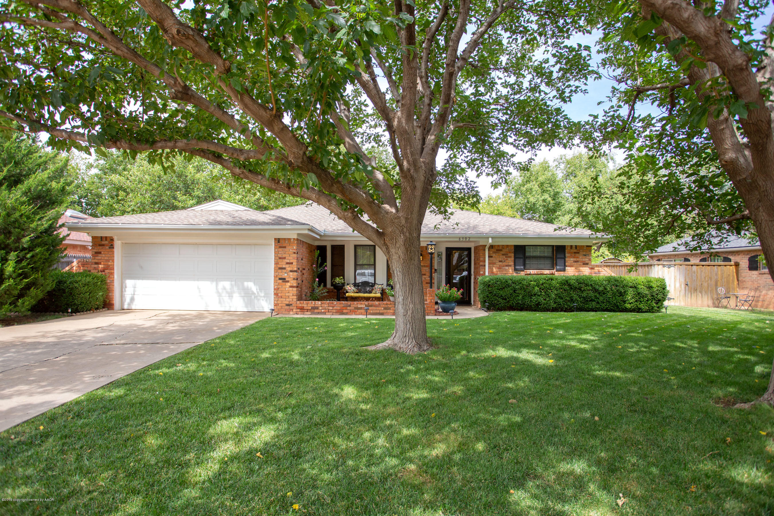6302 Elmhurst Road Amarillo, TX 79106 - Photo 1 of 29 a front view of a house with a garden and yard