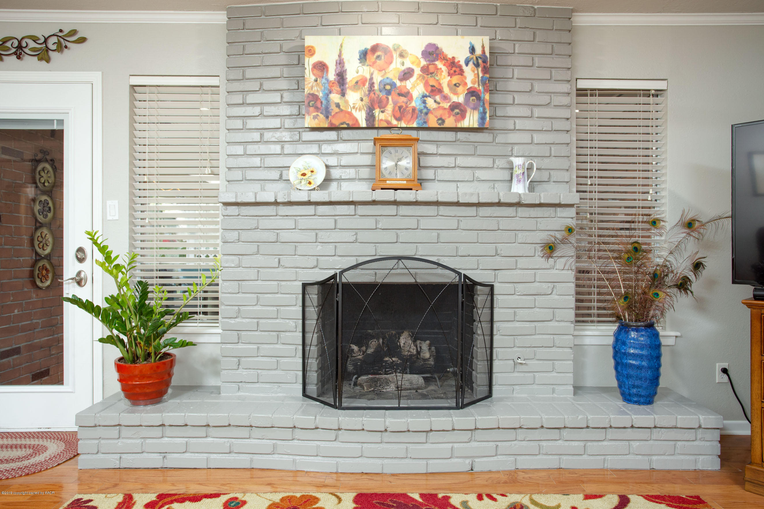 6302 Elmhurst Road Amarillo, TX 79106 - Photo 10 of 29 a room with a fireplace and potted plant