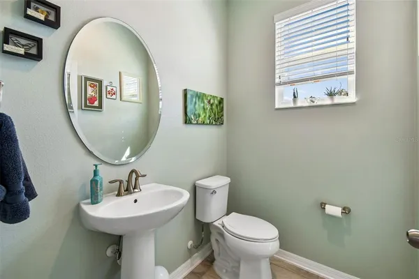 a kitchen with stainless steel appliances granite countertop a sink a stove a refrigerator a kitchen island with cabinets and couches