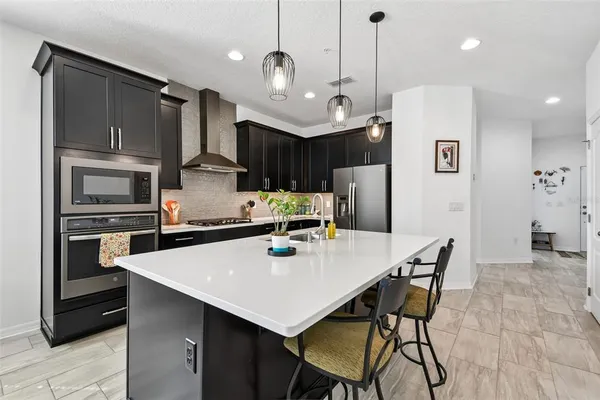 a view of a dining room with furniture a chandelier and wooden floor