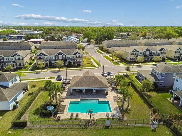 an aerial view of residential houses with outdoor space and ocean view