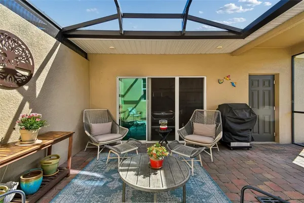 a view of a cafe with a table and chairs under an umbrella