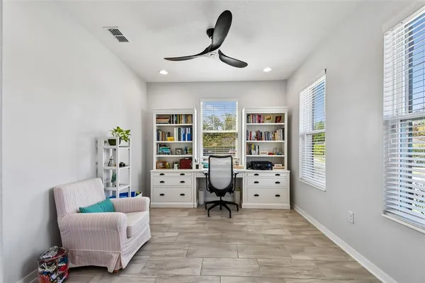 a view of a livingroom with workspace and a couch