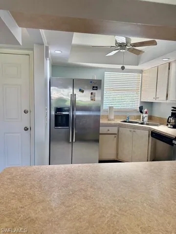 a kitchen with stainless steel appliances granite countertop a refrigerator and a sink