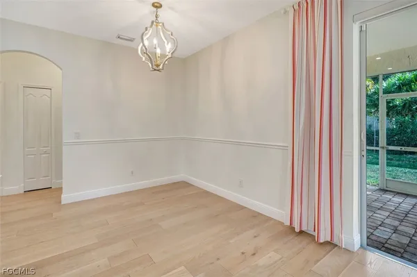 a view of a room with wooden floor and window