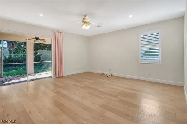 a metallic refrigerator freezer and a stove sitting inside of a kitchen