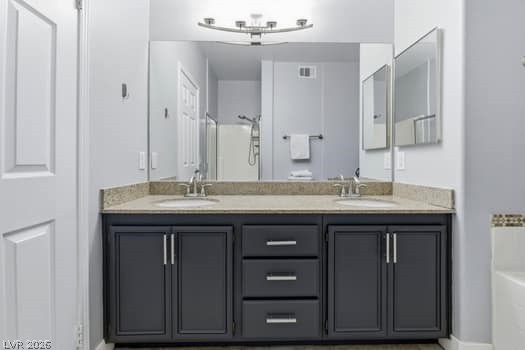 10550 West Alexander Road, Unit 2091 Las Vegas, NV 89129 - Photo 23 of 43 Dual sinks, custom lighting, and cabinetry in primary bathroom.