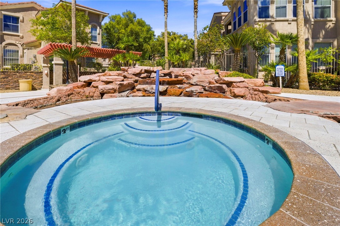 10550 West Alexander Road, Unit 2091 Las Vegas, NV 89129 - Photo 38 of 43 Waterfall landscaping behind hot tub.