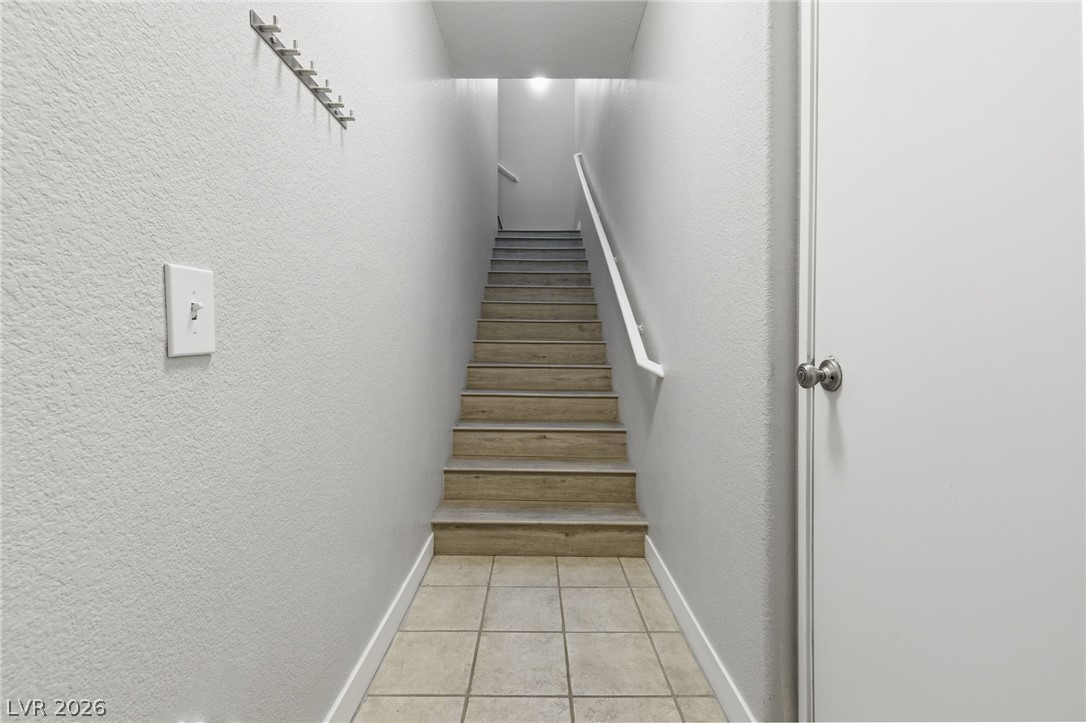 10550 West Alexander Road, Unit 2091 Las Vegas, NV 89129 - Photo 8 of 43 Staircase wraps around to top level living.