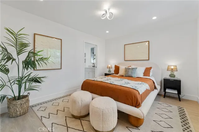a bedroom with a large bed and chandelier