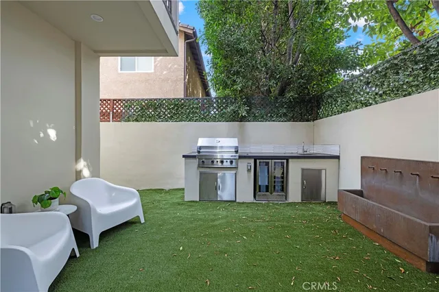 a living room with couches chair and a large window with garden view