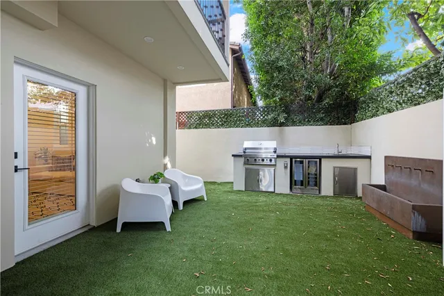 a front view of a house with garden and trees