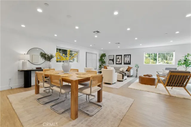 a living room with furniture a table and wooden floor