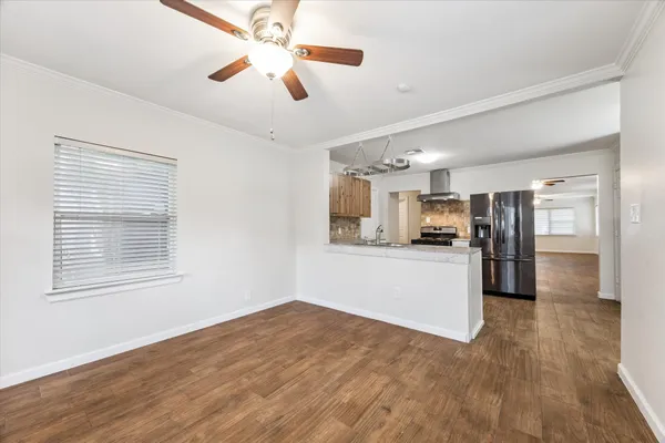 a view of kitchen with stainless steel appliances refrigerator stove microwave and cabinets